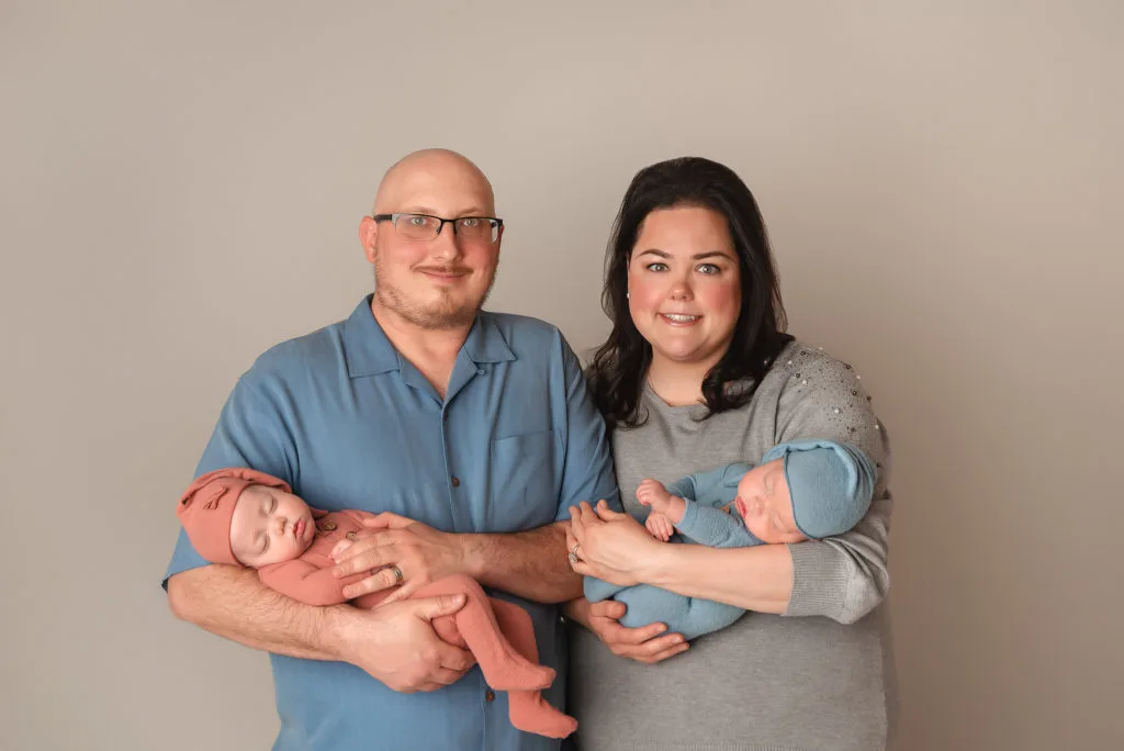 new parents hold twins during Las Vegas Studio newborn portraits
